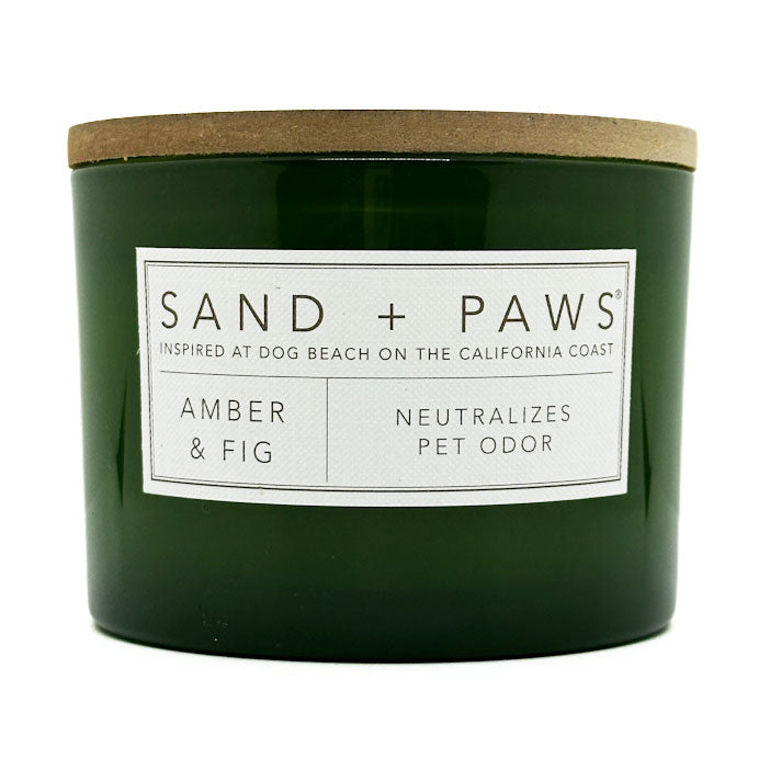 Green candle with a label on a white background