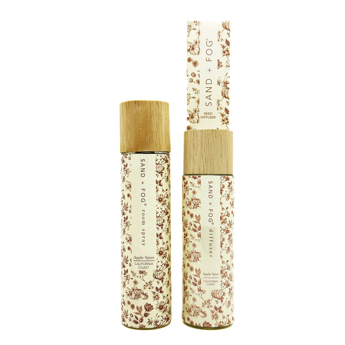 SAND + FOG Room Spray & Reed Diffuser floral-patterned bottles with wooden caps on a white background