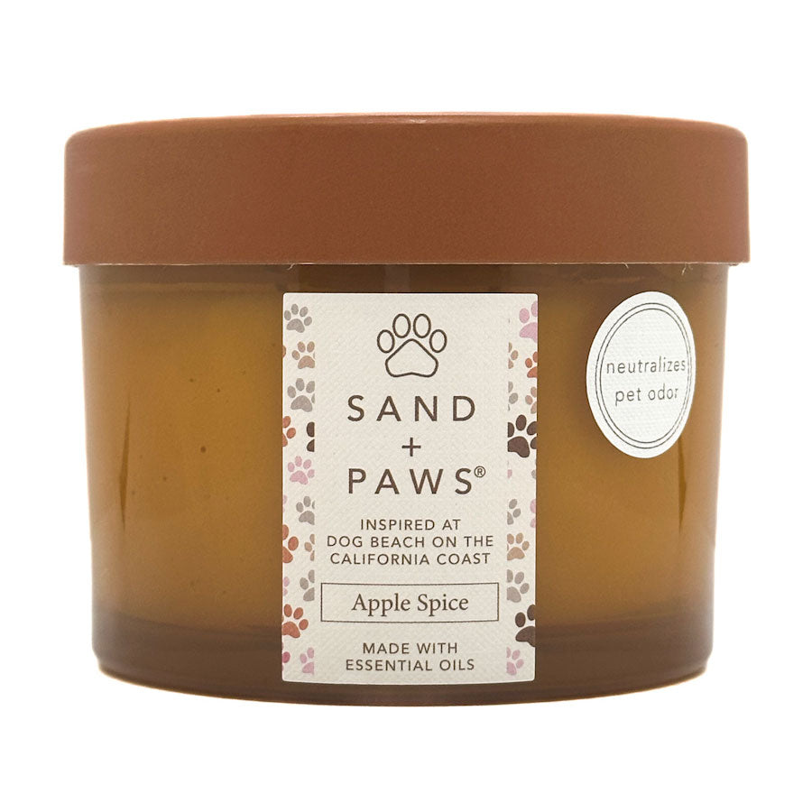 Jar of Sand + Paws Apple Spice candle with a label on a white background