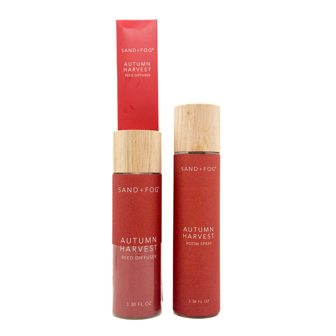 Two red bottles with wooden caps labeled 'Autumn Harvest' by Sand + Fog on a white background.