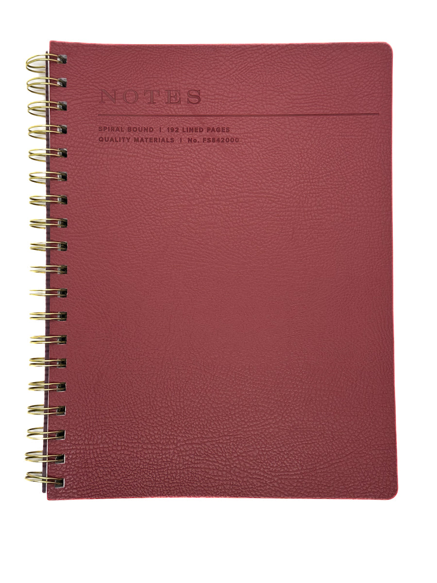 Red notebook with gold spiral binding on a white background