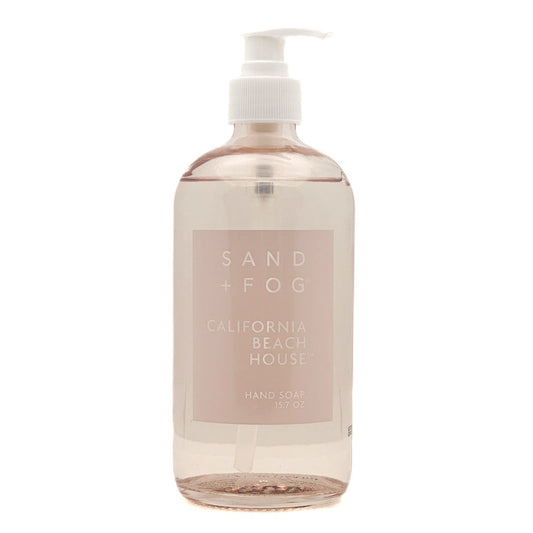 Hand soap bottle labeled 'Sand + Fog California Beach House' on a white background