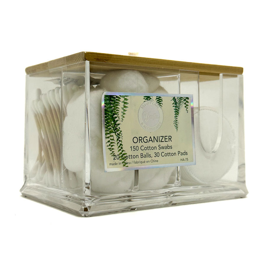 Clear plastic organiser with cotton swabs, cotton balls, and cotton pads on a white background