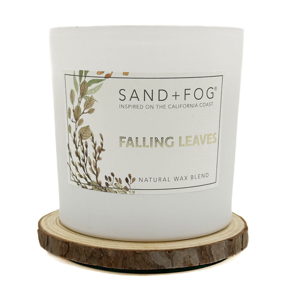 Falling Leaves candle with 'Sand + Fog' label on a white background