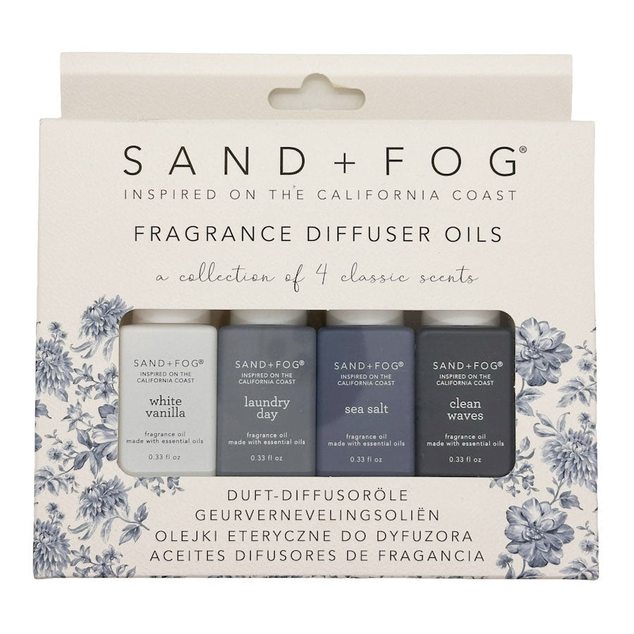 Packaging of Sand + Fog fragrance diffuser oils with floral design on a white background