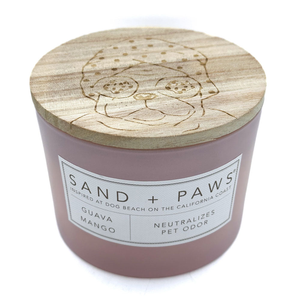 Guava Mango Candle with wooden lid featuring a dog design, labeled 'Sand + Paws'.