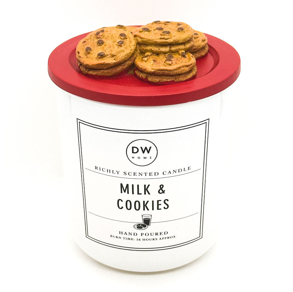 Candle with cookie-themed lid labeled 'Milk & Cookies' by DW Home on a white background