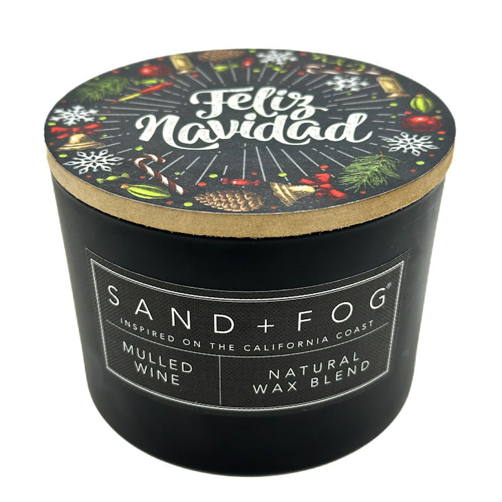Mulled Wine black candle with 'Feliz Navidad' lid featuring holiday designs, branded as Sand + Fog.