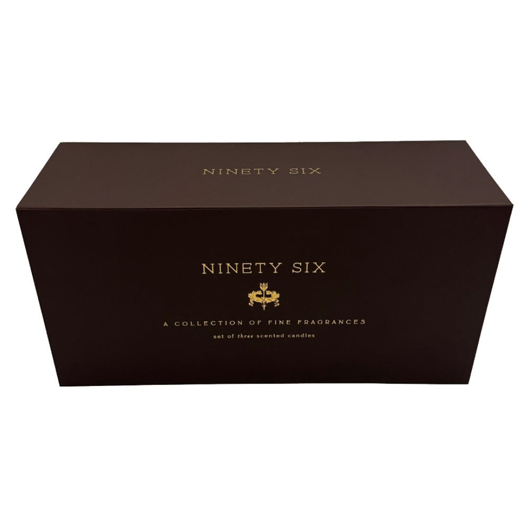 A dark brown rectangular box for Ninety Six scented candles, featuring gold foil lettering and a small crest logo on the front, set against a plain white background.