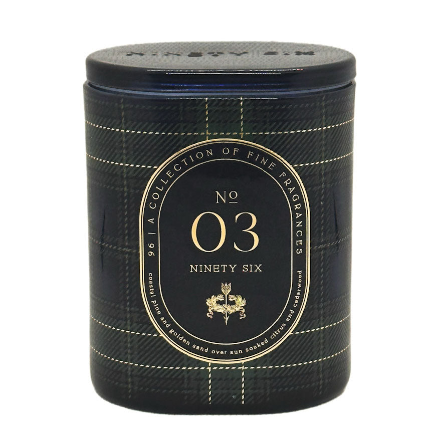 A cylindrical scented candle with a black and navy plaid pattern and gold lettering. The front label reads 'No 03 Ninety Six' and features a gold crest, with 'NINETY SIX' embossed on the lid.