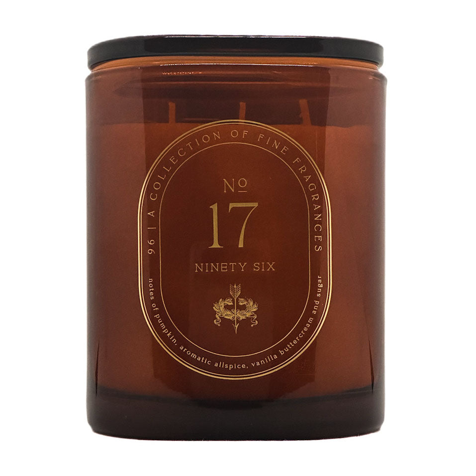 An amber glass jar candle with a lid and a gold circular label reading 'No. 17 Ninety Six' and 'A Collection of Fine Fragrances'.