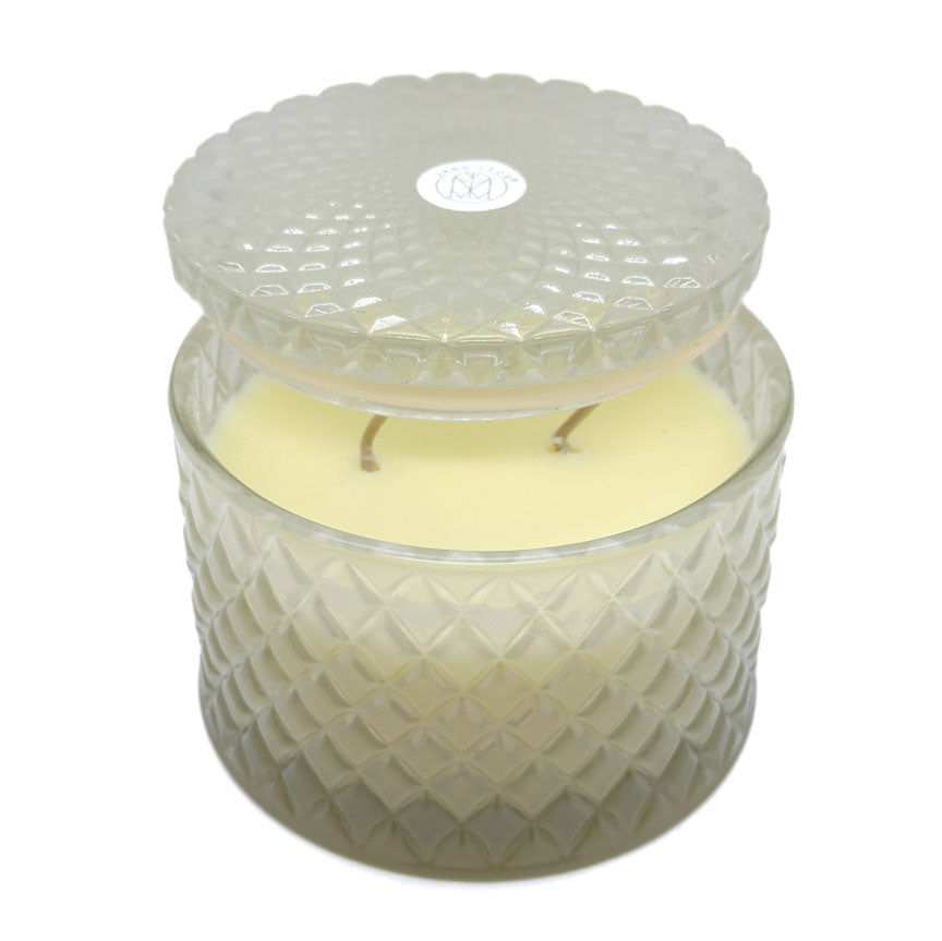 Ocean Mist decorative candle by SAND + FOG in a textured glass jar with a lid on a white background