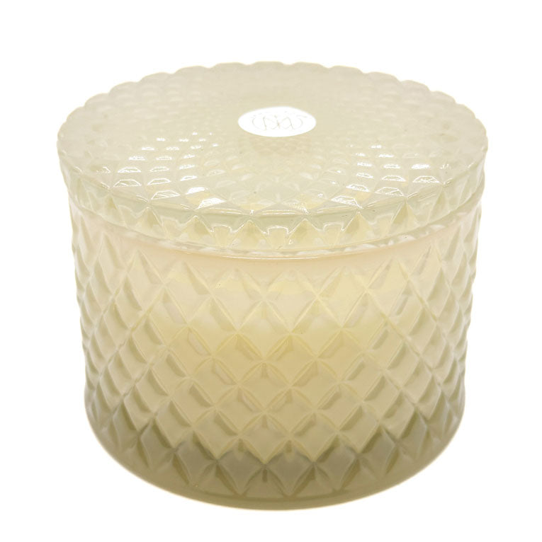Ocean Mist decorative candle by SAND + FOG in a textured glass holder on a white background