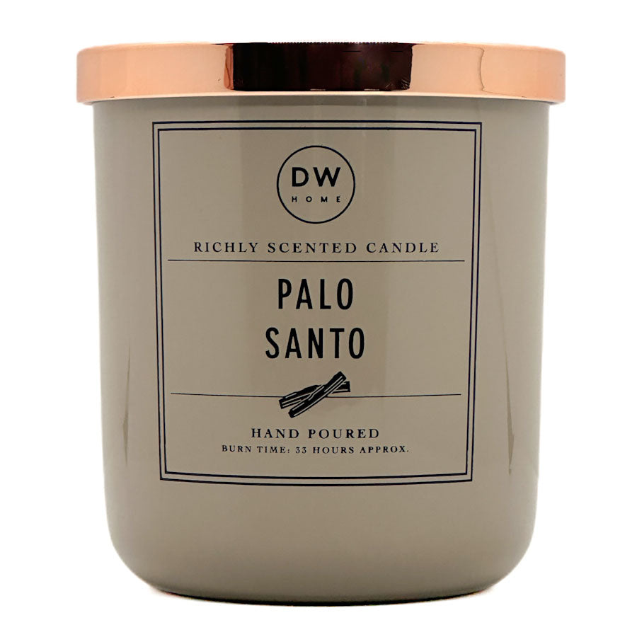 A candle jar with a matte taupe-gray body and a metallic rose gold lid, featuring a front label that reads 'DW HOME' and 'PALO SANTO'.
