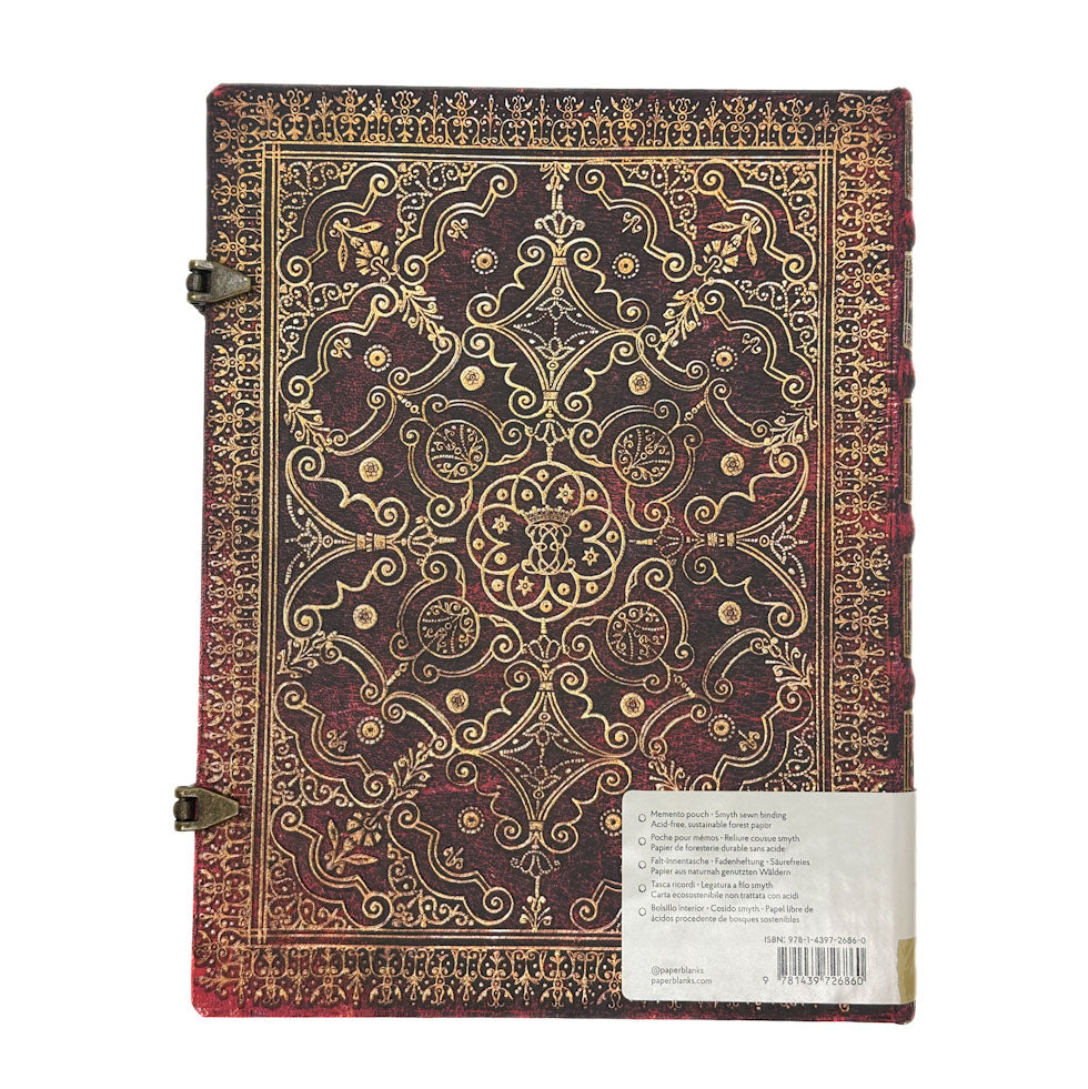 Decorative notebook with intricate gold patterns on a white background