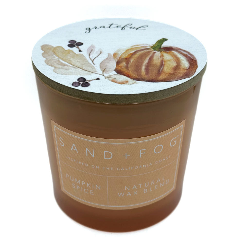 SAND + FOG Candle with a pumpkin spice label on a white background