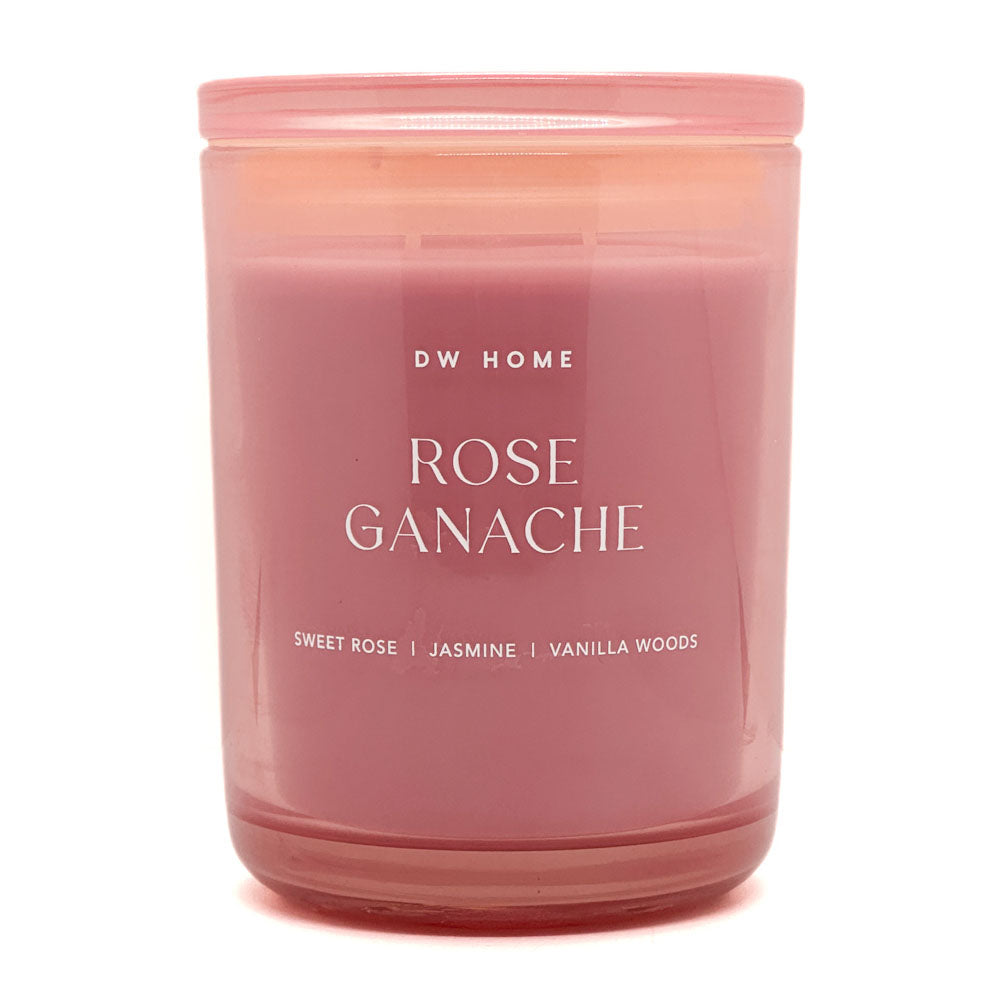 Pink candle labeled 'Rose Ganache' by DW Home on a white background