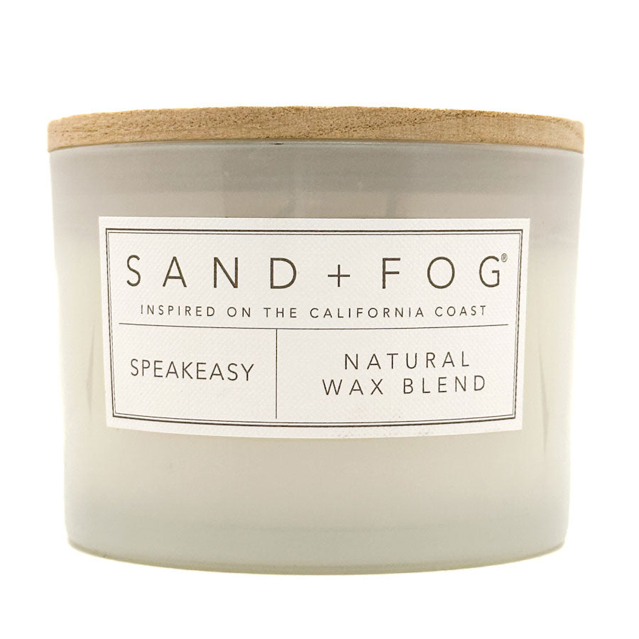 Speakeasy candle with 'Sand + Fog' label on a white background
