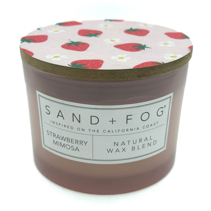 Strawberry Mimosa candle with strawberry patterned lid and 'Sand + Fog' label on a white background