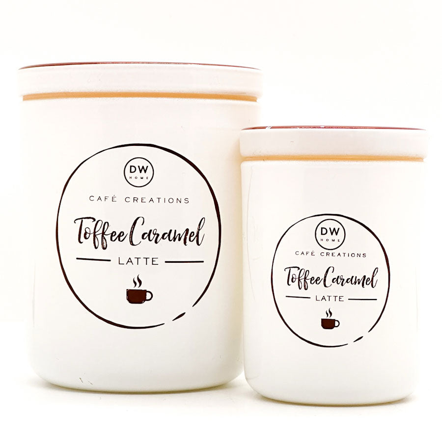 Two candles labeled 'Toffee Caramel Latte' by DW Home on a white background