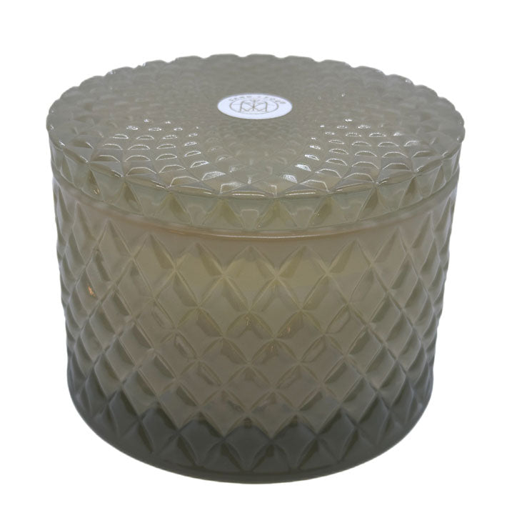 Vanilla Sandalwood decorative candle by SAND + FOG in a textured glass jar with a lid on a white background