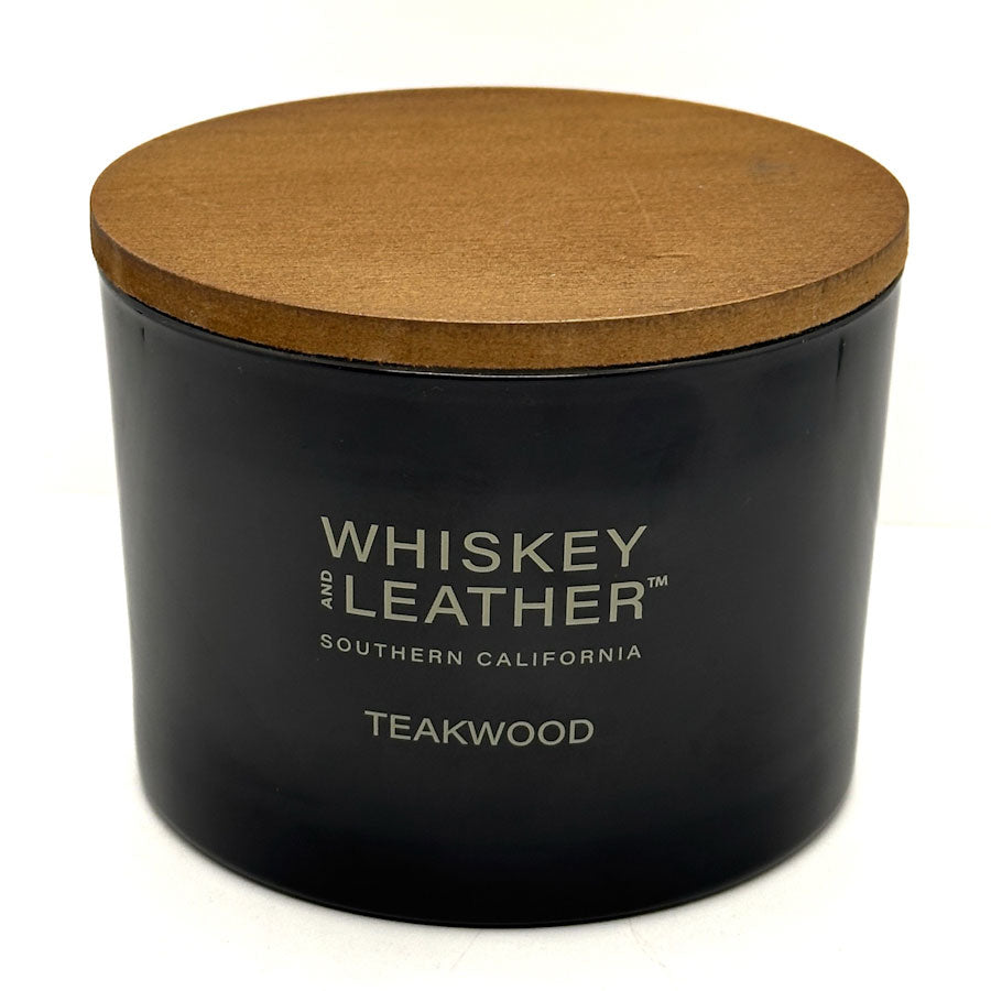 Teakwood black candle jar with a wooden lid labeled 'Whiskey and Leather' on a white background