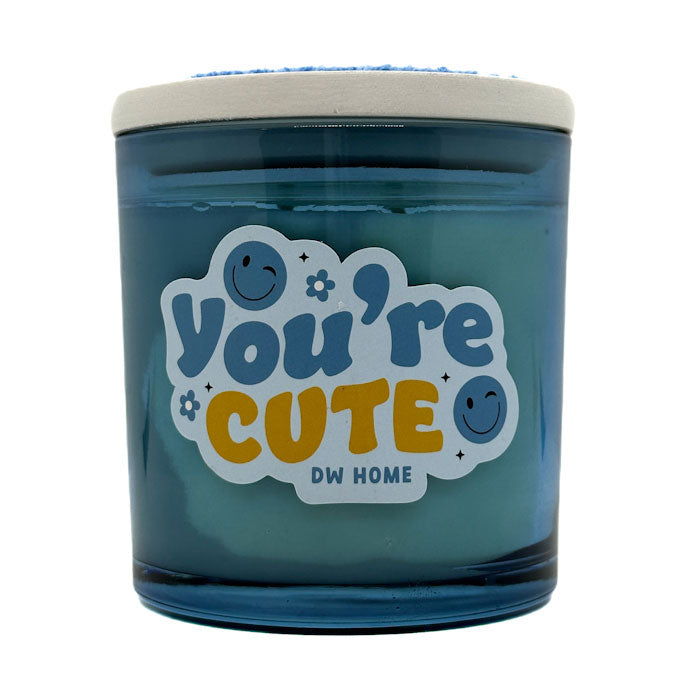 Blue candle jar with 'You're Cute' text and DW Home logo on a white background