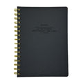 Fringe Studio Black notebook with gold spiral binding on a white background