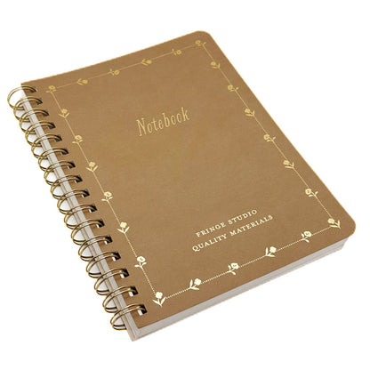 A5 spiral-bound notebook with a textured brown cover and gold foil detailing, including a decorative border and the text 'Notebook' and 'FRINGE STUDIO QUALITY MATERIALS'.
