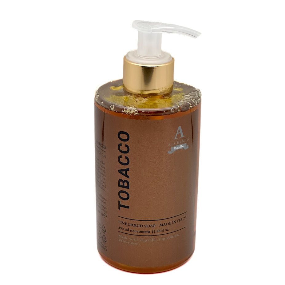 A bottle of Alchimia Tobacco Fine Liquid Soap with a gold pump and clear cap, filled with amber-coloured liquid, on a white background.
