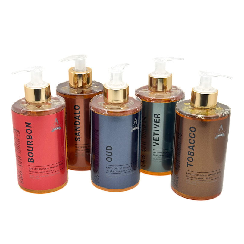 Five pump bottles of Alchimia  cliquis soap arranged in a row on a white background, with labels reading BOURBON, SANDALO, OUD, VETIVER, and TOBACCO.