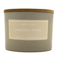 Ambered Wood Candle with 'Sand + Fog' label on a white background