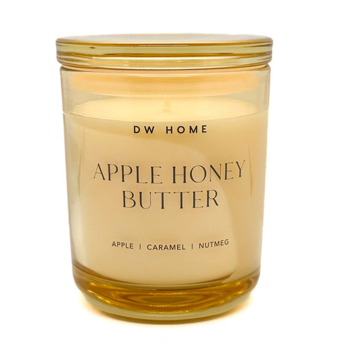 DW Home Apple Honey Butter candle in a clear glass jar with a gold lid on a white background
