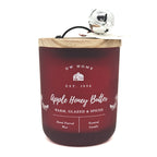 Apple Honey Butter Red candle with wooden lid and silver bell, featuring DW Home branding.