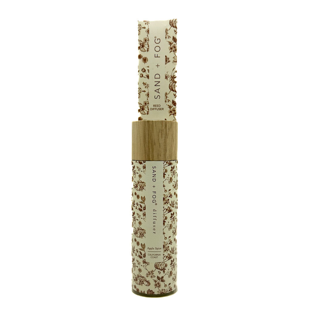 SAND + FOG Apple Spice Reed Diffuser bottle with floral design on a white background