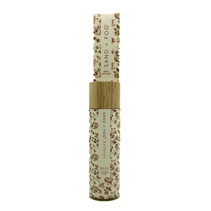 SAND + FOG Apple Spice Reed Diffuser bottle with floral design on a white background