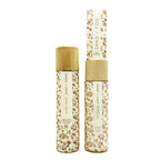 SAND + FOG Room Spray & Reed Diffuser floral-patterned bottles with wooden caps on a white background