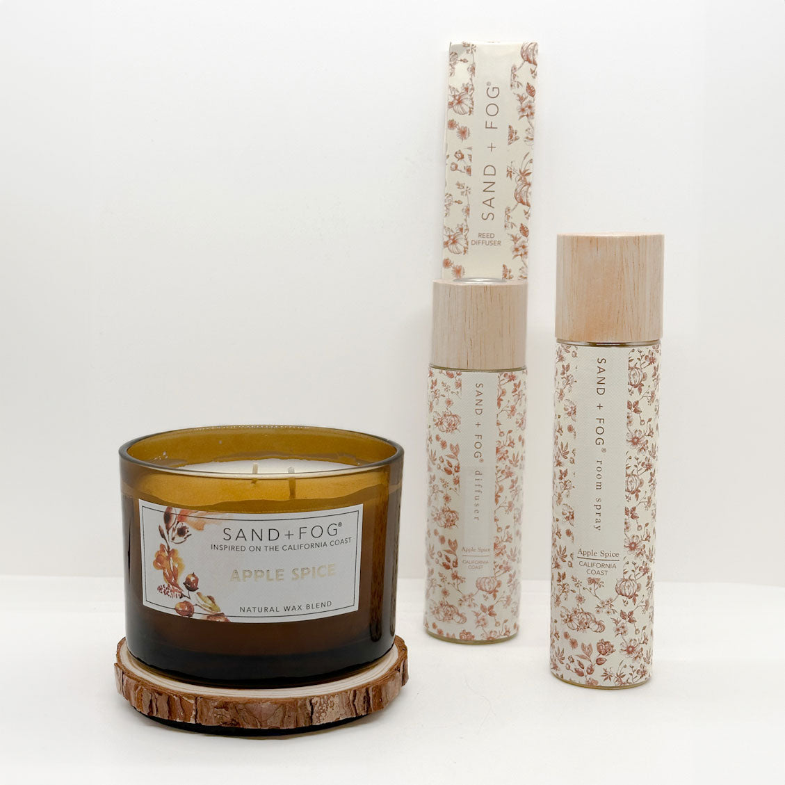 Apple spice candle, room spray and reed diffuser with 'Sand + Fog' branding on a white background