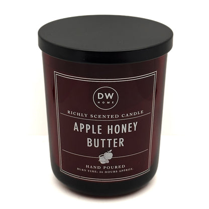 A dark brown scented candle in a black glass jar with a black lid, featuring a label that reads 'DW HOME' and 'APPLE HONEY BUTTER'.