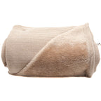 A folded beige blanket with a ribbed knit texture on one side and a plush faux-fur fleece lining on the other, shown on a plain white background.