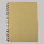 Fringe Studio yellow notebook with spiral binding on a grey background