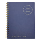 Fringe Studio - Blue notebook with gold spiral binding on a white background
