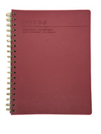 Red notebook with gold spiral binding on a white background