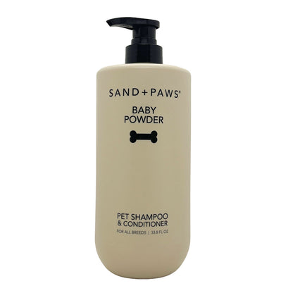 Beige bottle of Sand + Paws Baby Powder pet shampoo and conditioner on a white background