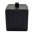 Black ribbed container with a lid on a white background