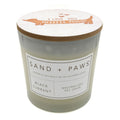 Black Currant candle labeled 'Sand + Paws' with a decorative lid on a white background