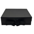 Black gift box with a bow on a white background