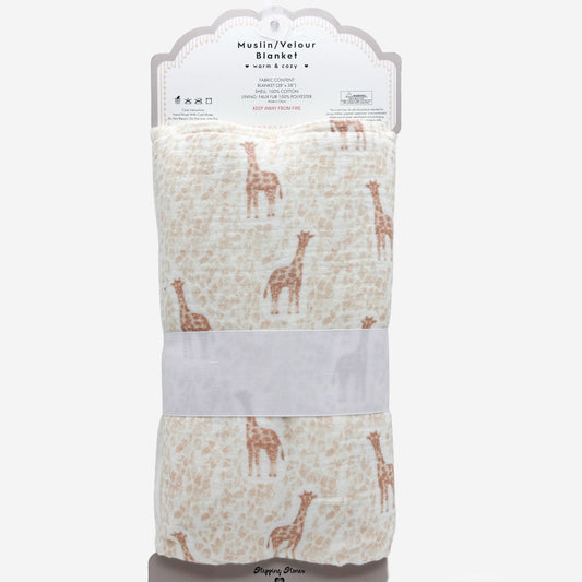 A folded muslin/velvet baby blanket with a giraffe pattern, packaged with a white paper header card and a light gray band, on a plain light gray background.