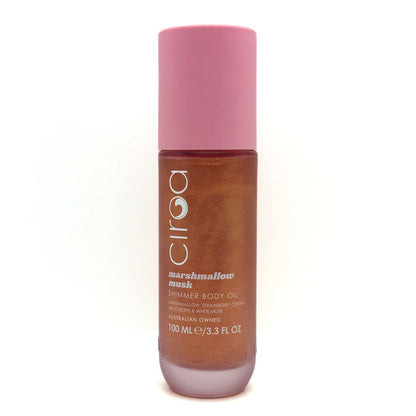 A bottle of Ciroa Marshmallow Musk Shimmer Body Oil, featuring a pink cap and a brown translucent bottle showing the shimmering oil inside, set against a plain white background.