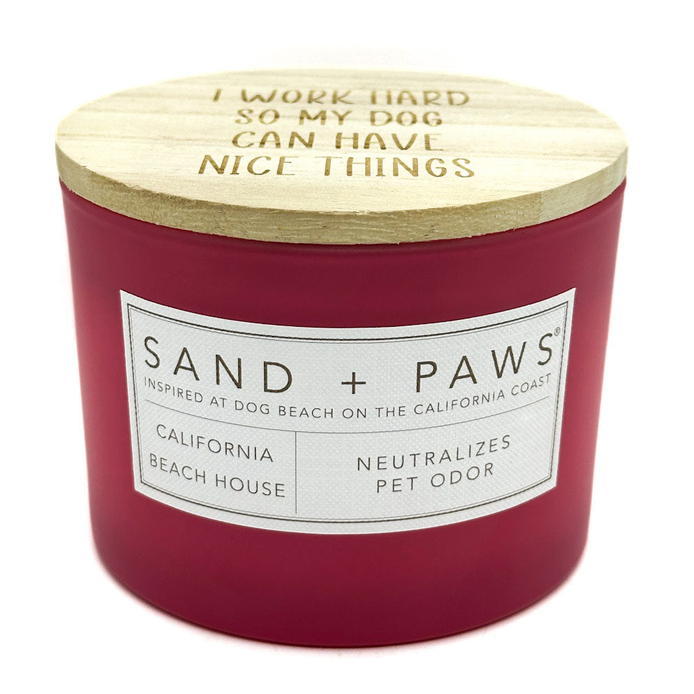 California Beach house red candle with wooden lid featuring text and 'Sand + Paws' branding on a white background
